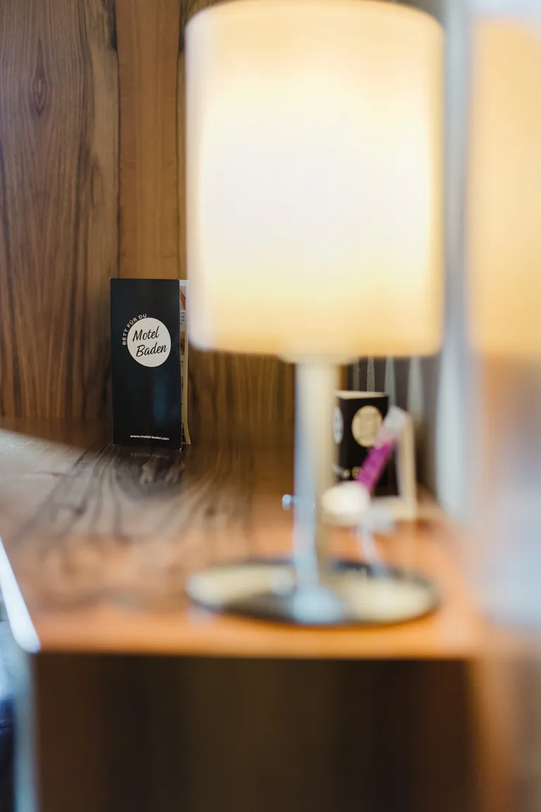 Nachttischlampe mit Flyer im Motel Baden